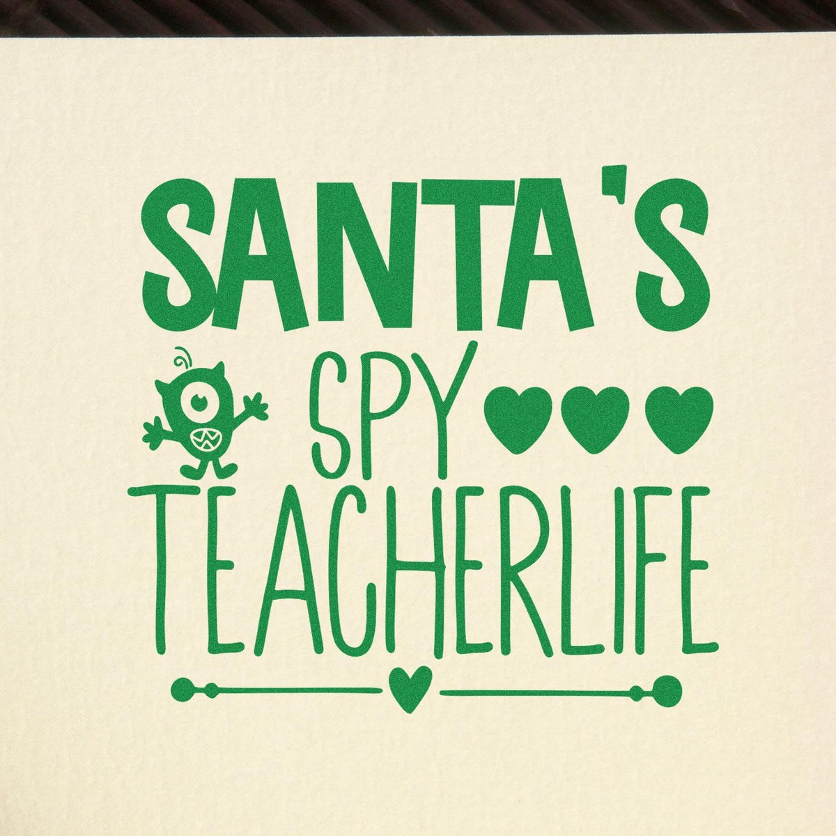 Santa's Spy Teacher Life rubber stamp shown in green ink, stamped for projects such as behavior album page.