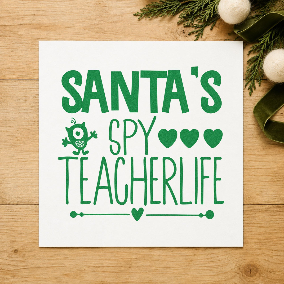 Santa's Spy Teacher Life craft stamp imprint in green ink on a handmade project, one idea being note home cards.