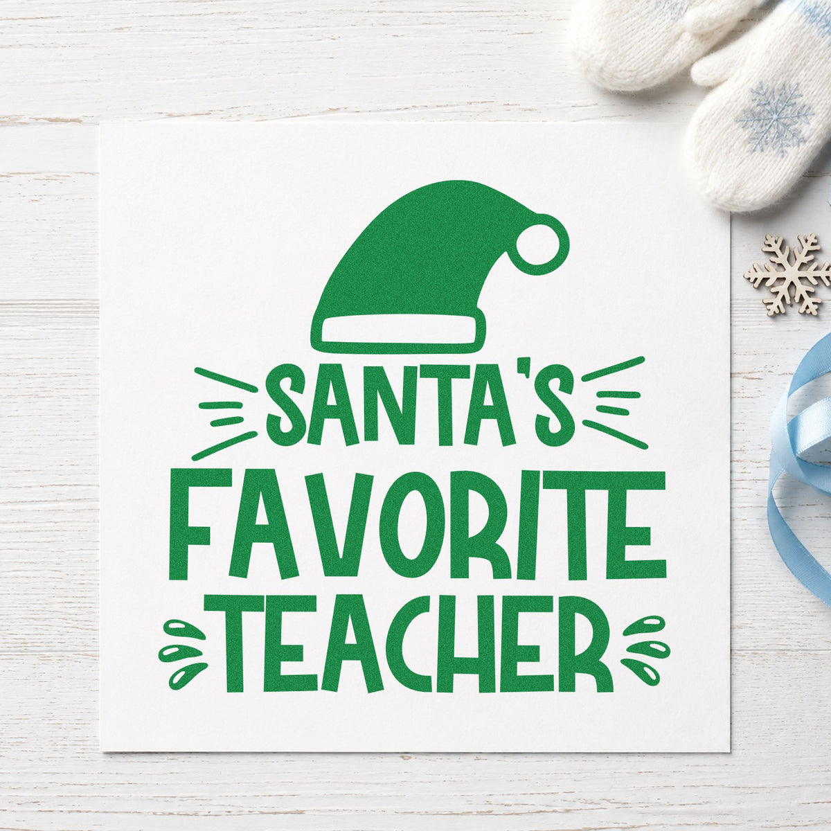 Santa's Favorite Teacher Hat craft stamp imprinted in green ink on paper, a design suited to framed door plate.