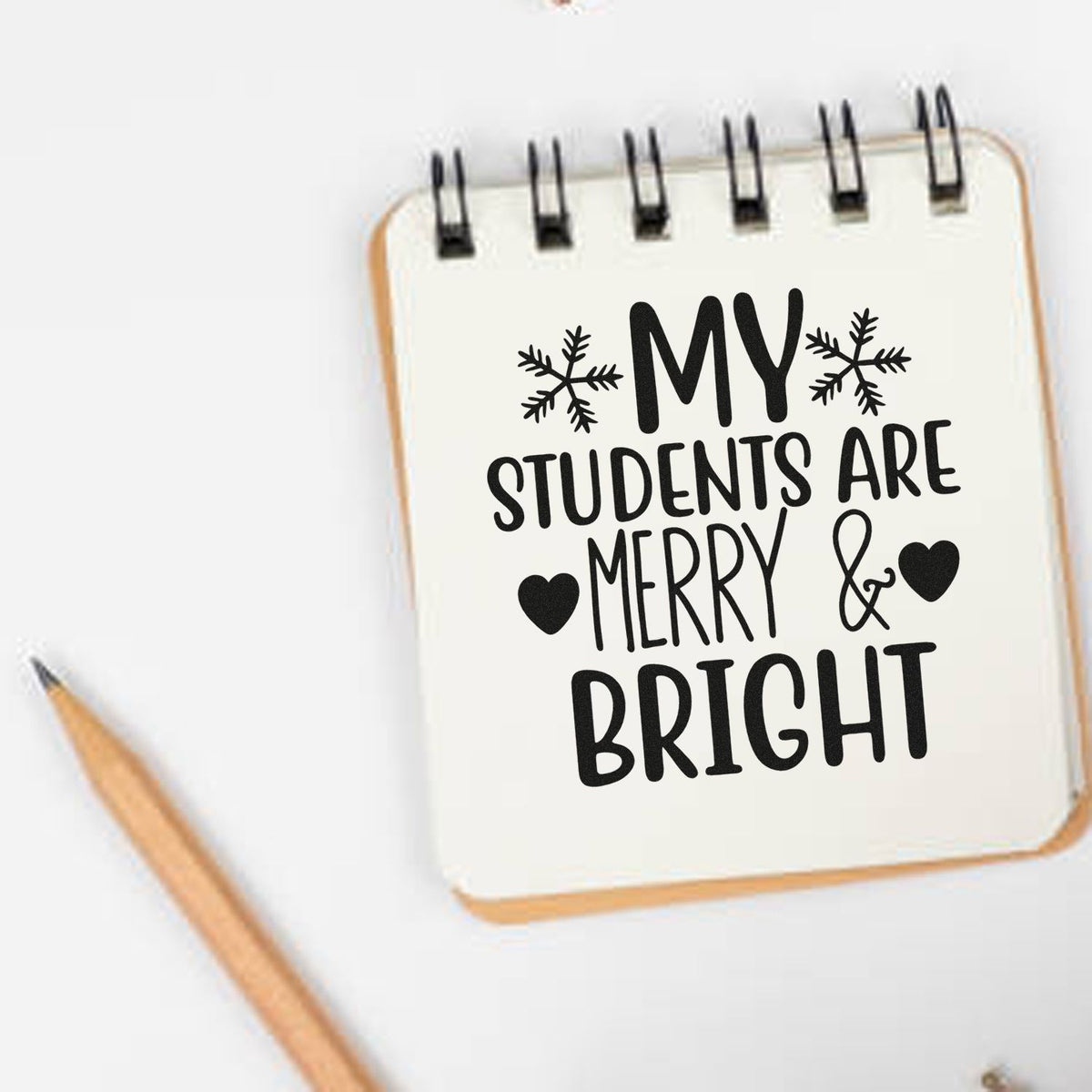 Premium Wooden Students Merry And Bright Stamp - Vintage Pro imprint stamped in black ink. The words "My students are merry & bright" include two snowflakes and solid hearts.