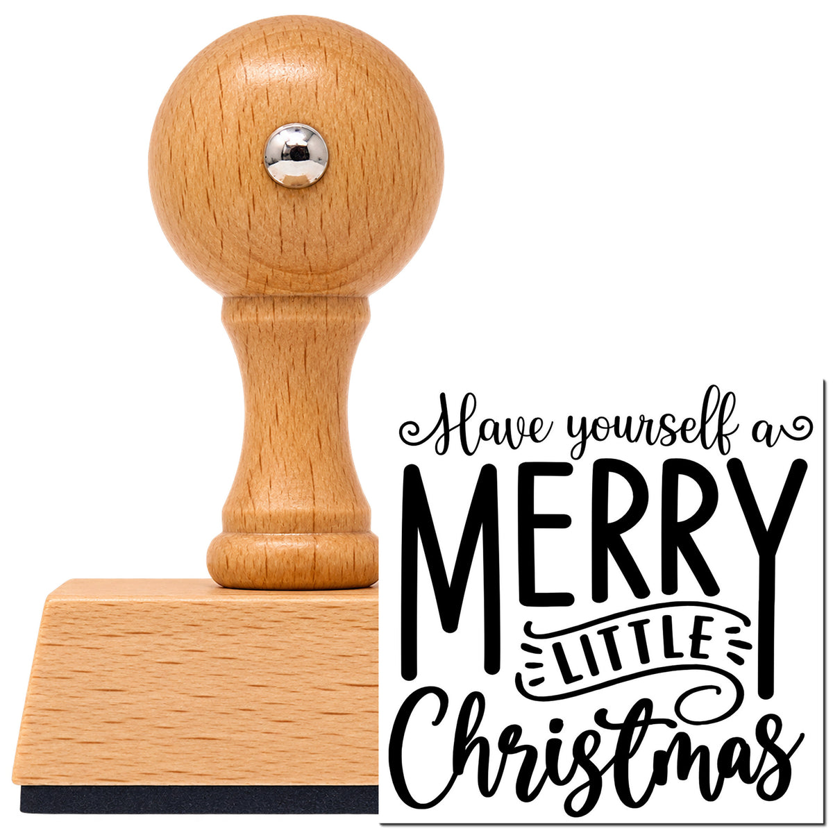 Have Yourself A Merry Little Christmas Ribbon Lettering Vintage Pro rubber stamp in European beech wood with a round knob handle, shown beside its black imprint.