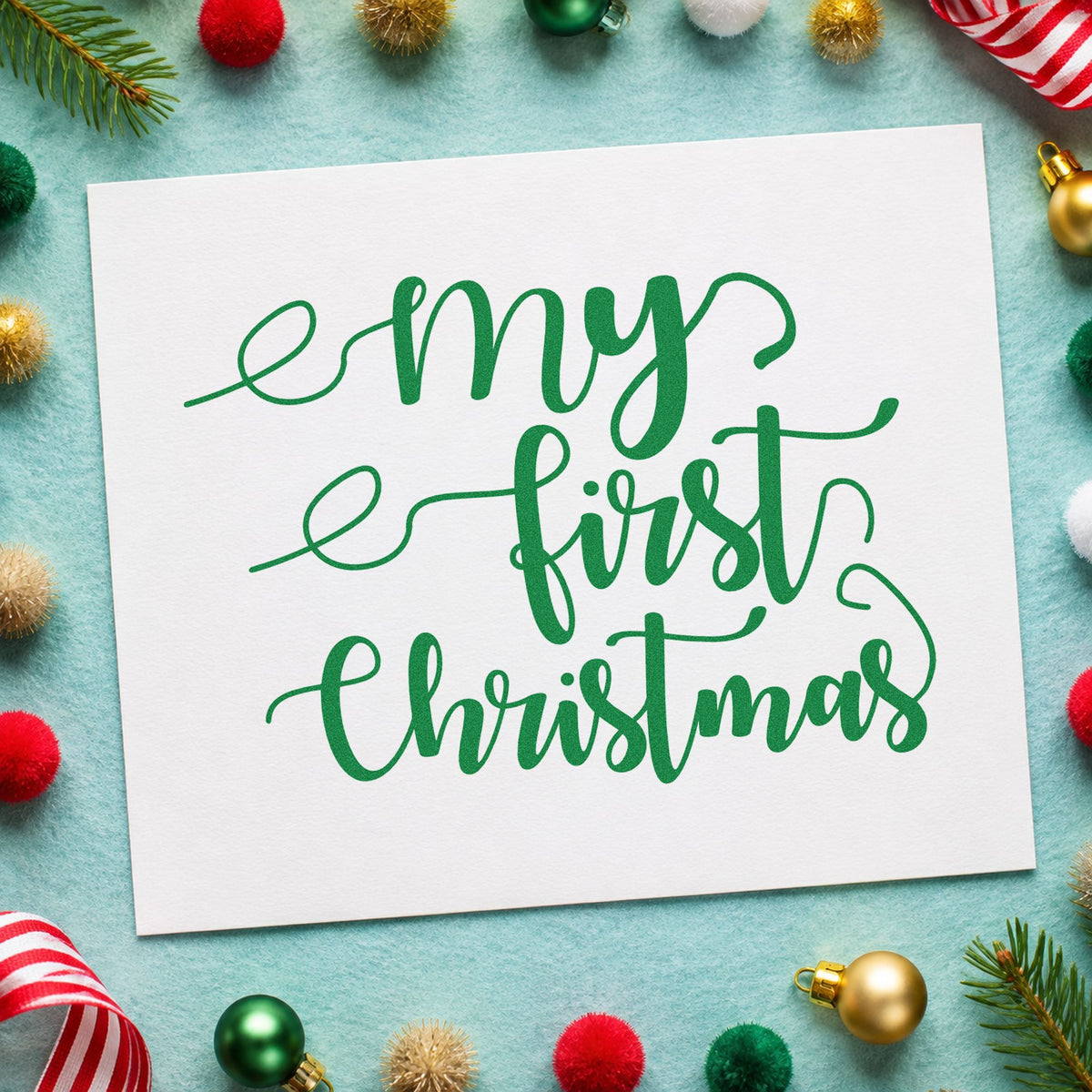 My First Christmas Script craft stamp imprinted in green ink on paper, a design suited to framed nursery wall.