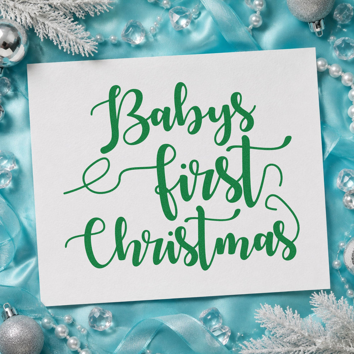 Baby's First Christmas Script craft stamp imprint in green ink on a handmade project, one idea being announcement tags.