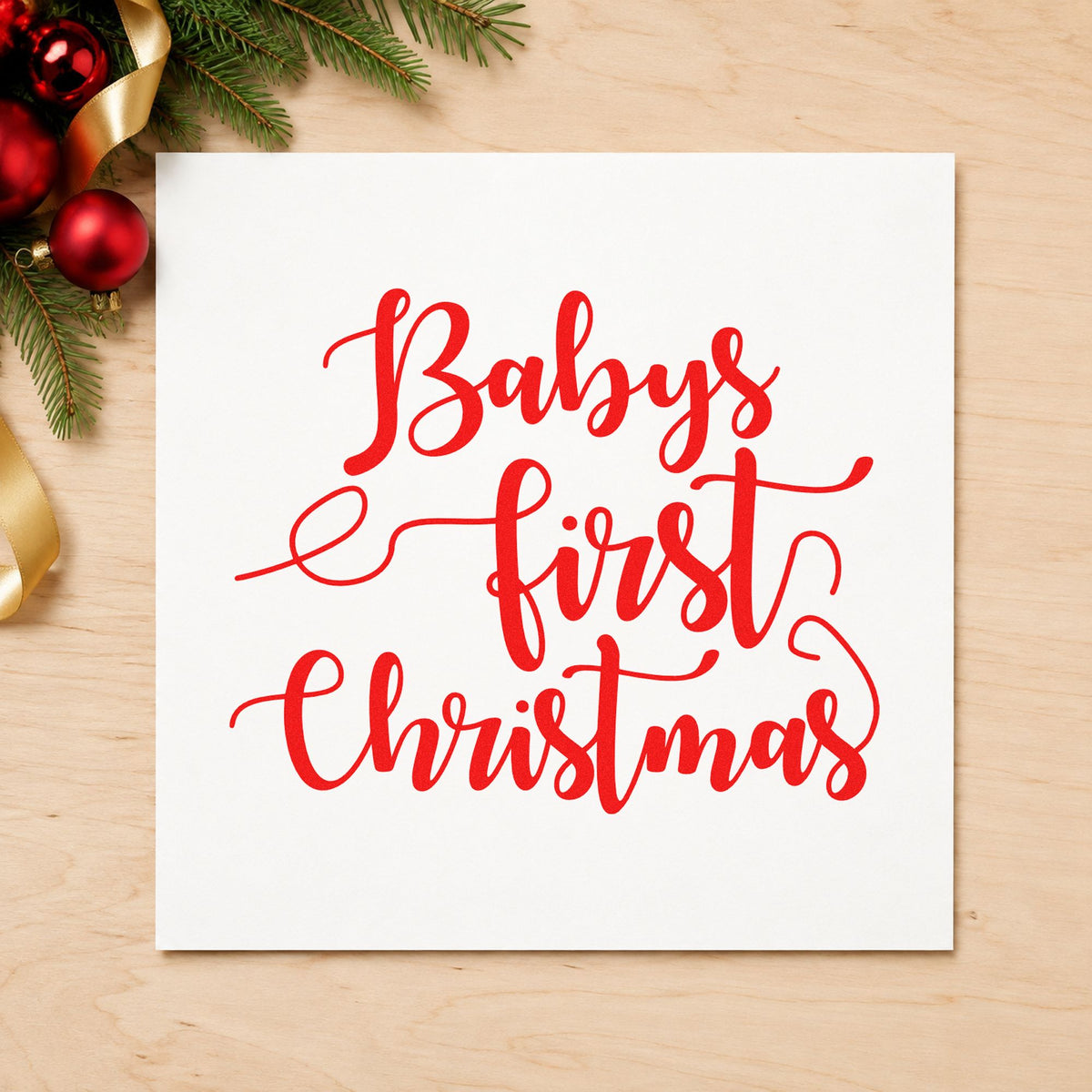 Baby's First Christmas Script craft stamp in red ink on cardstock, an easy option for swaddle edge printing.