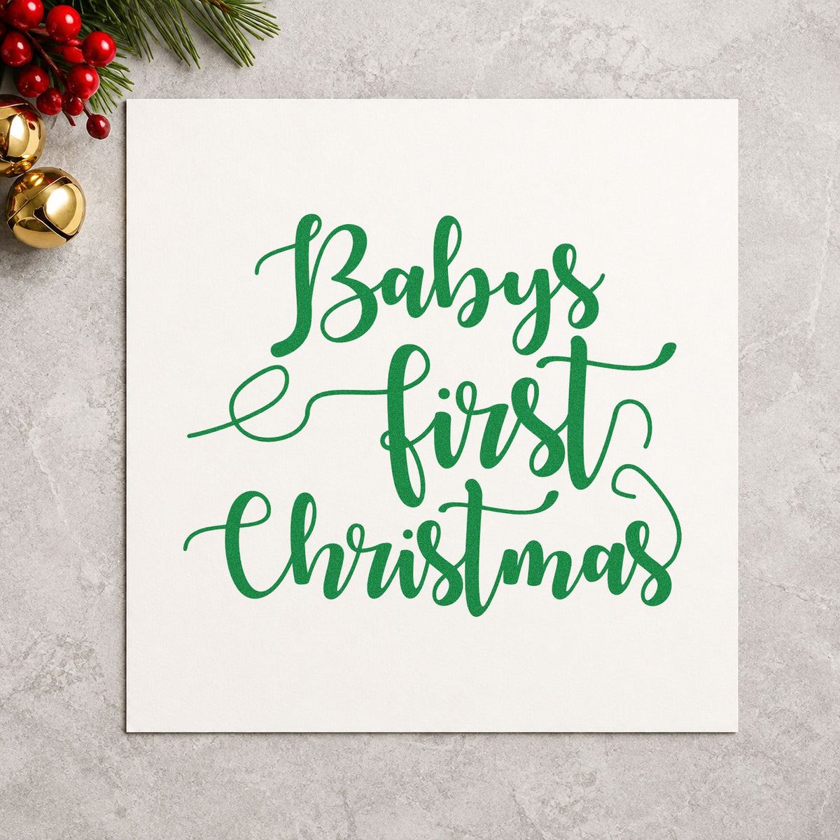 Baby's First Christmas Script craft stamp imprint in green ink on a handmade project, one idea being meet baby cards.