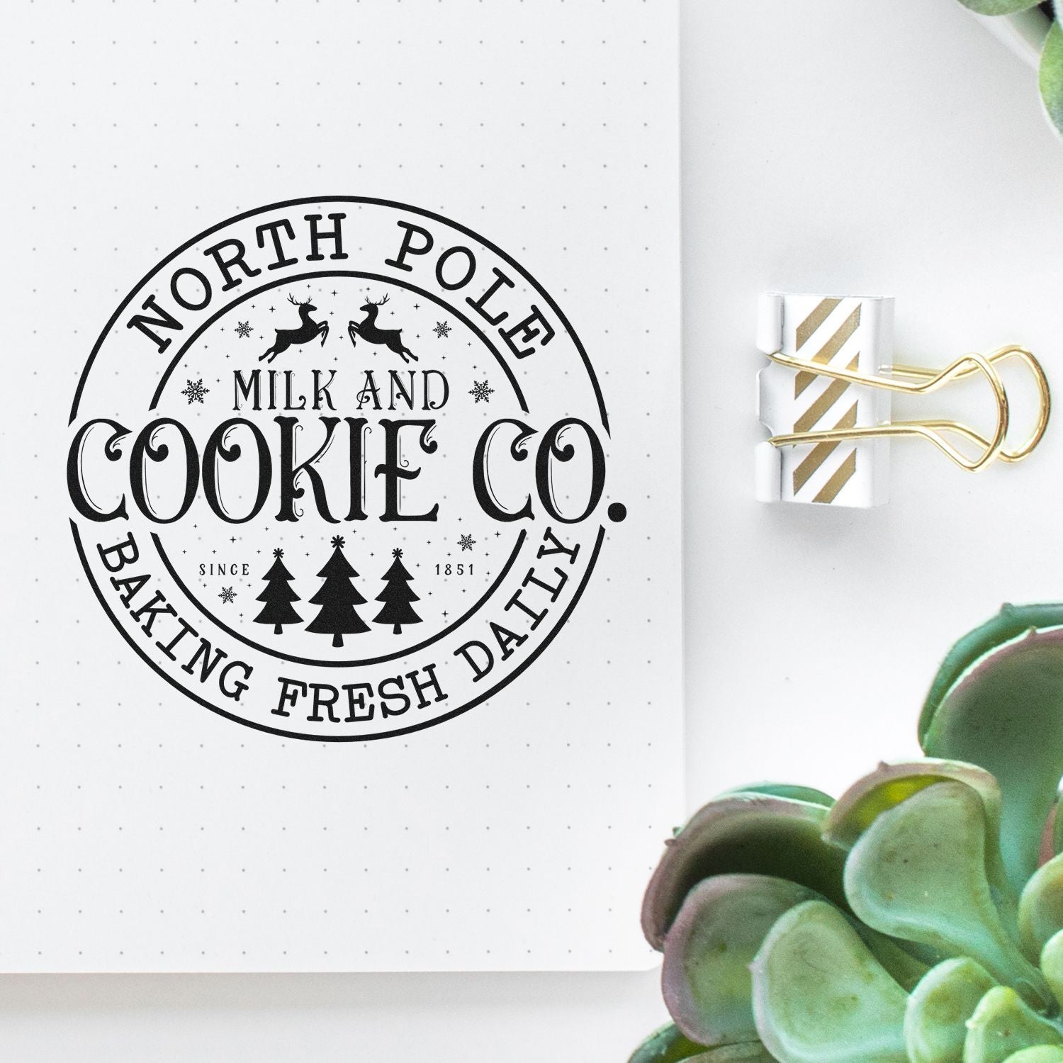 North Pole Milk and Cookie Co. custom rubber stamp design for Christmas baking, shown on a notebook page.