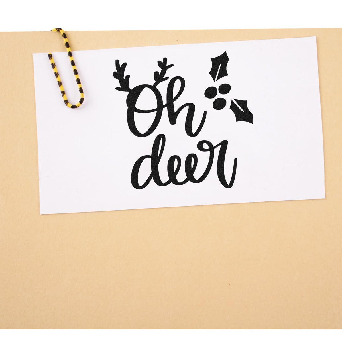 Vintage Pro Oh Deer Holly Antlers Premium Wooden Stamp imprint stamped in black ink. The words "Oh deer" appear with antlers and bold holly leaves and berries.