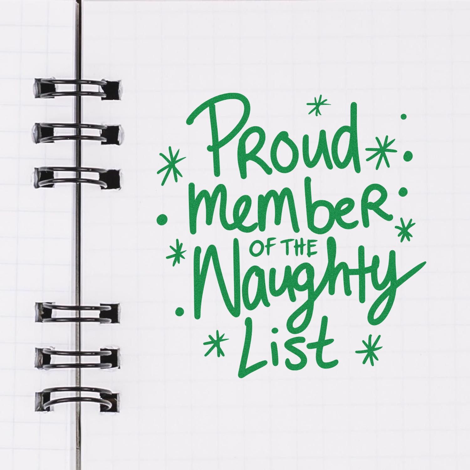 Green holiday rubber stamp design reading Proud member of the naughty list on a notebook page, perfect for planner stamping.