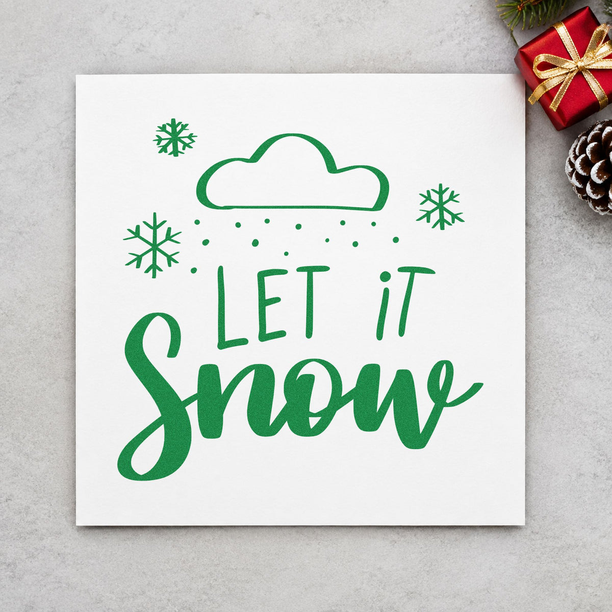 Let It Snow Cloud craft stamp imprint in green ink on a handmade project, one idea being weather kit tags.