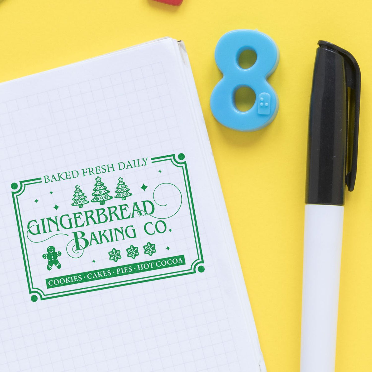 Gingerbread Baking Company Daily rubber stamp shown in green ink, stamped for projects such as market setup album.