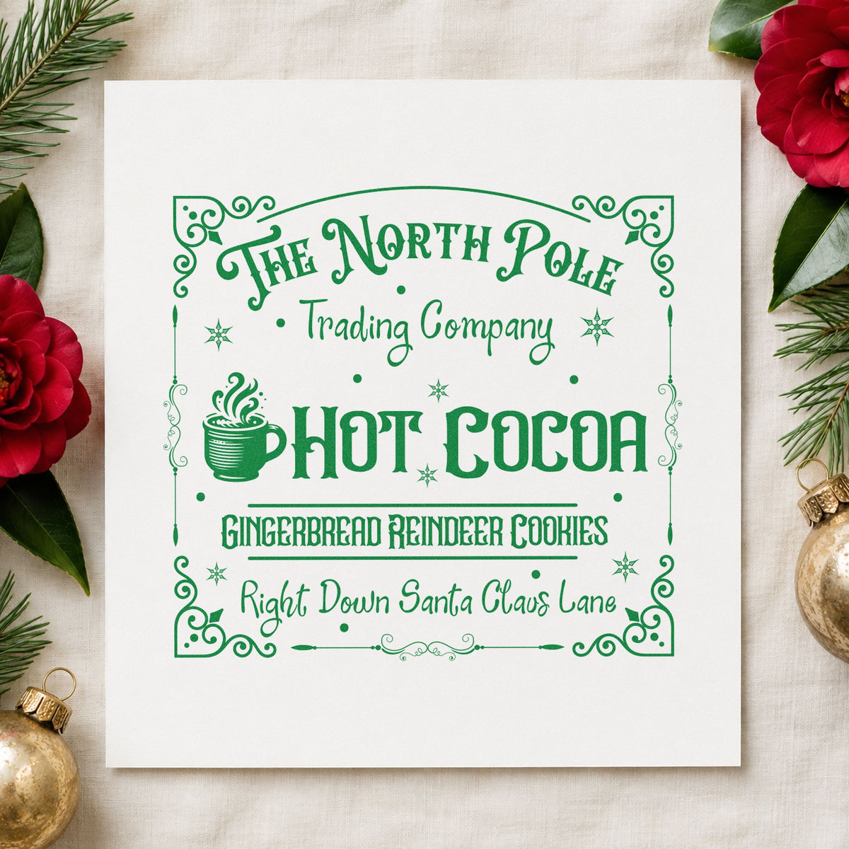 North Pole Trading Hot Cocoa craft stamp imprint in green ink on a handmade project, one idea being pickup slip cards.