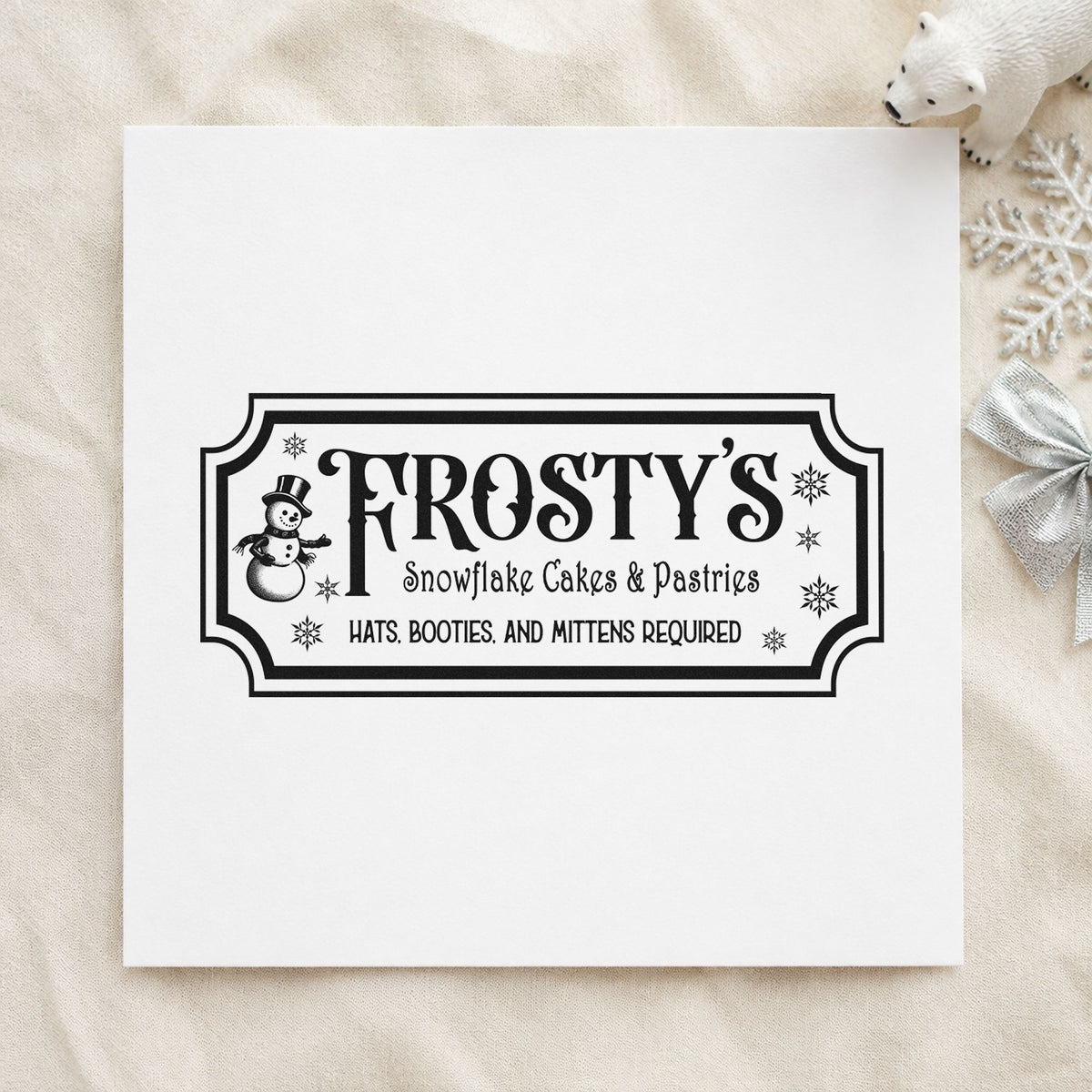Frosty's Snowflake Cafe Pastries craft stamp imprint in black ink on a handmade project, one idea being bakery box tags.