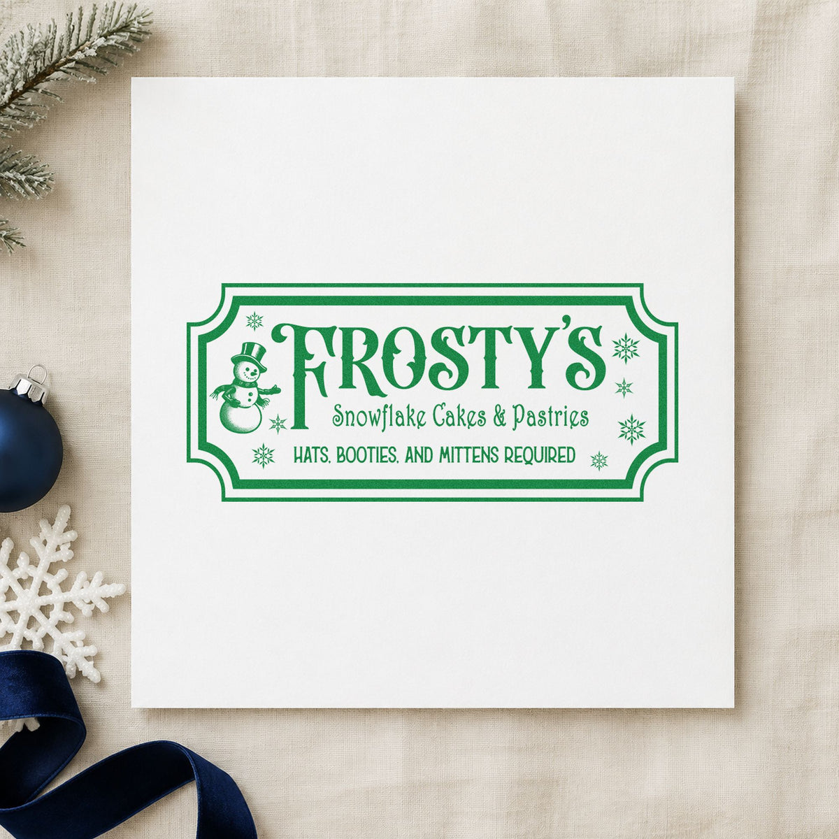 Frosty's Snowflake Cafe Pastries craft stamp imprint in green ink on a handmade project, one idea being standing order cards.