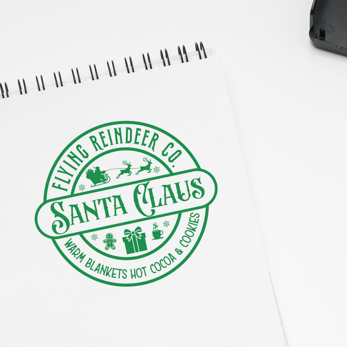 Flying Reindeer Santa Claus Badge rubber stamp shown in green ink, stamped for projects such as service album page.