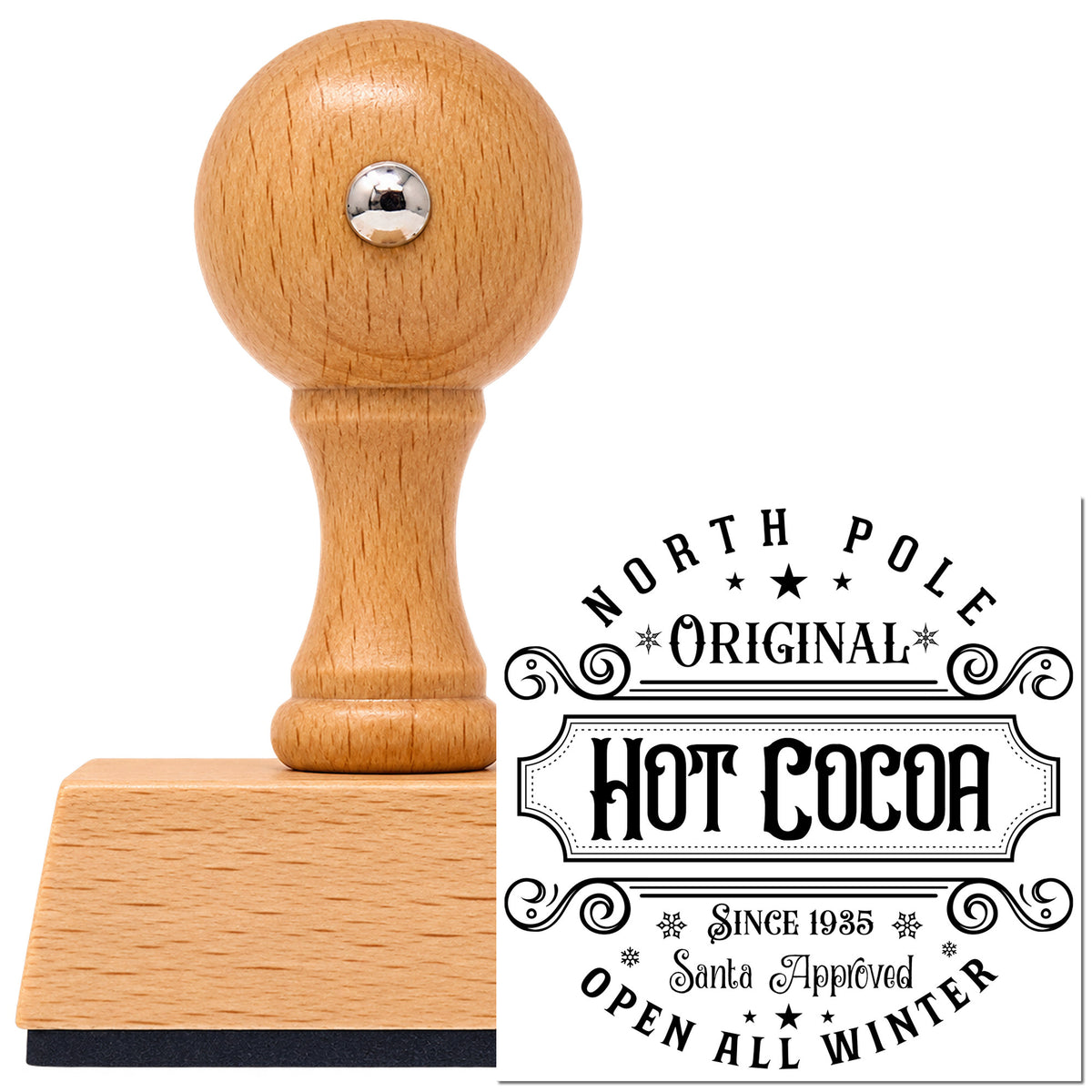 North Pole Original Hot Cocoa Lettering Vintage Pro rubber stamp in European beech wood with a round knob handle, shown beside its black imprint.