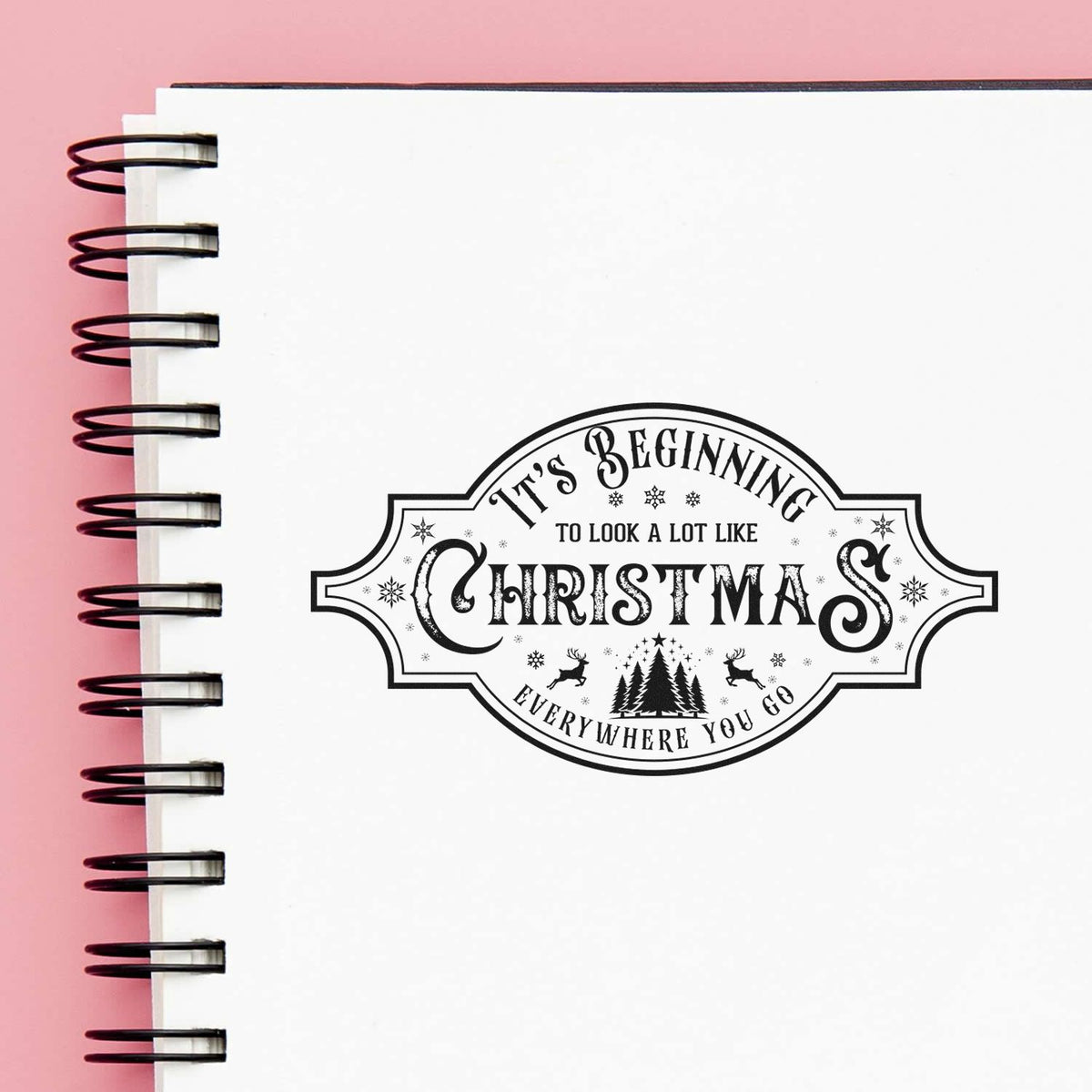 Vintage Pro Beginning To Look Like Christmas Premium Wooden Stamp imprint stamped in black ink. A decorative vintage label reads "It's beginning to look a lot like Christmas everywhere you go" with small trees and ornamental details.