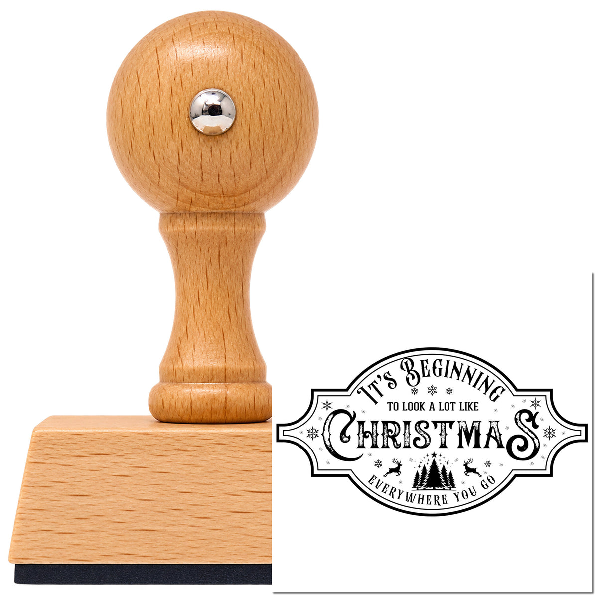 Beginning To Look Like Christmas Vintage Pro rubber stamp in European beech wood with a round knob handle, shown beside its black imprint.