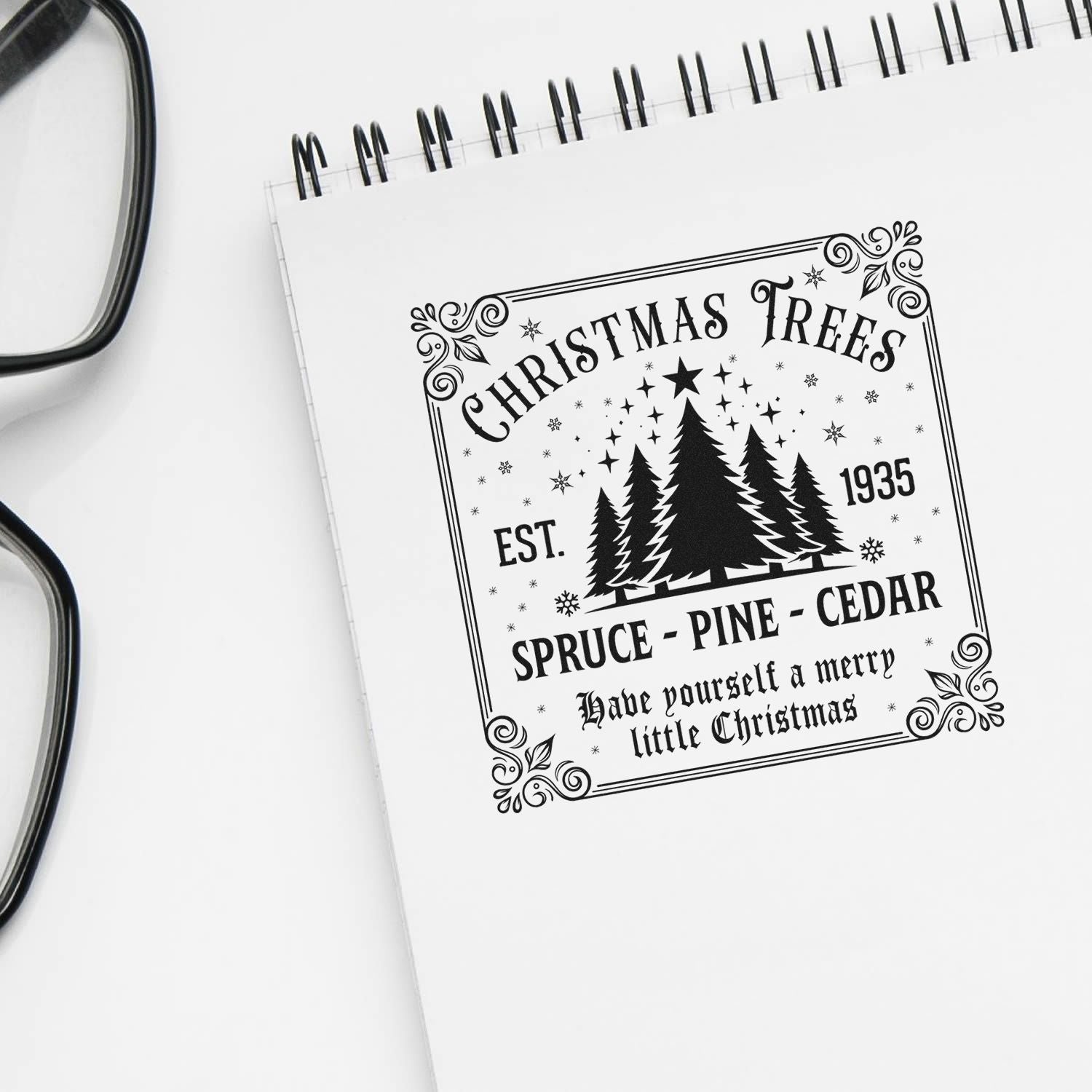 Vintage Christmas trees rubber stamp design mockup on notebook, featuring spruce, pine, cedar, and a merry little Christmas message.