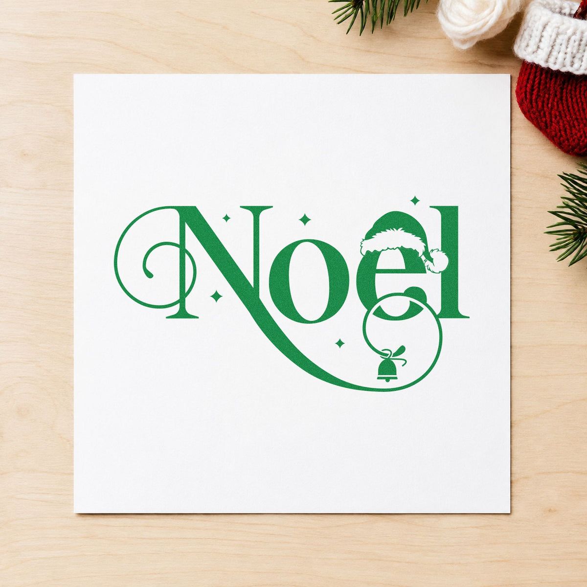 Noel Santa Hat Bell craft stamp imprinted in green ink on paper, a design suited to framed door top.