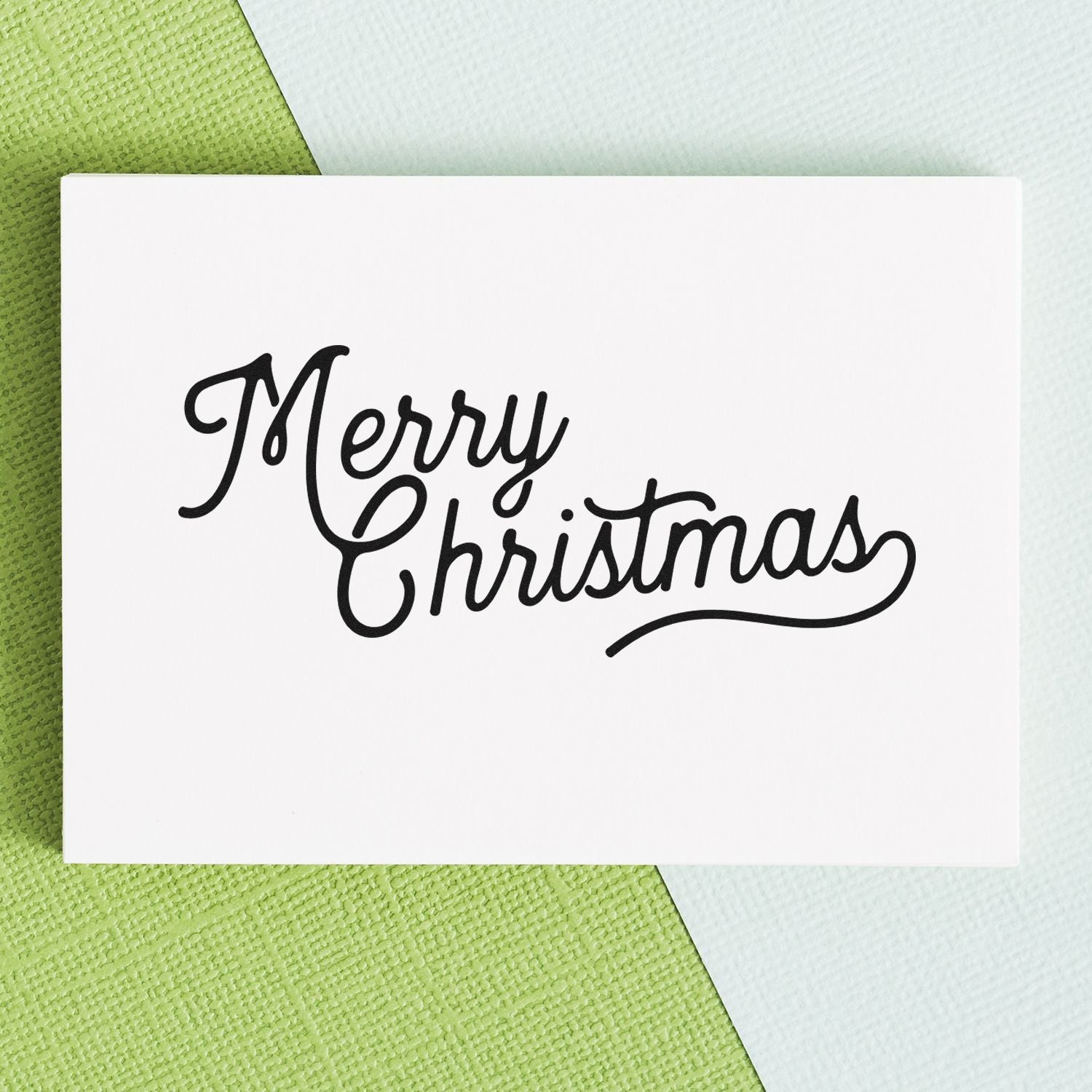 Merry Christmas script rubber stamp design on white card, ideal for holiday cards, gift tags, and festive packaging.