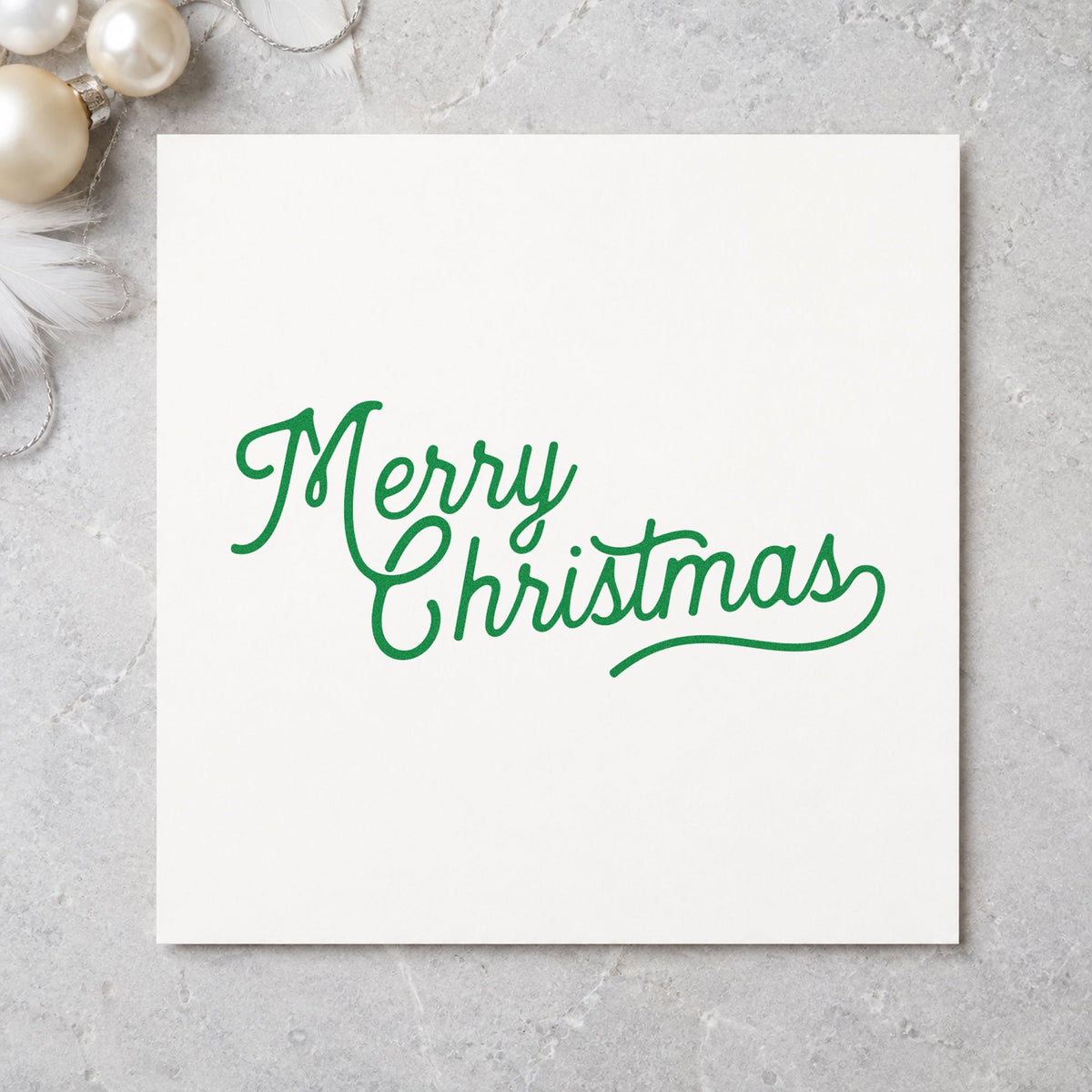 Merry Christmas Script Greeting craft stamp imprinted in green ink on paper, a design suited to framed studio print.