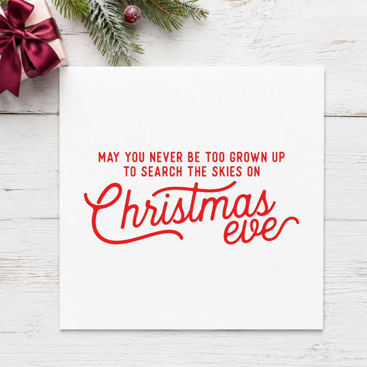Never Grown Up Christmas Eve craft stamp in red ink on cardstock, an easy option for blanket edge printing.
