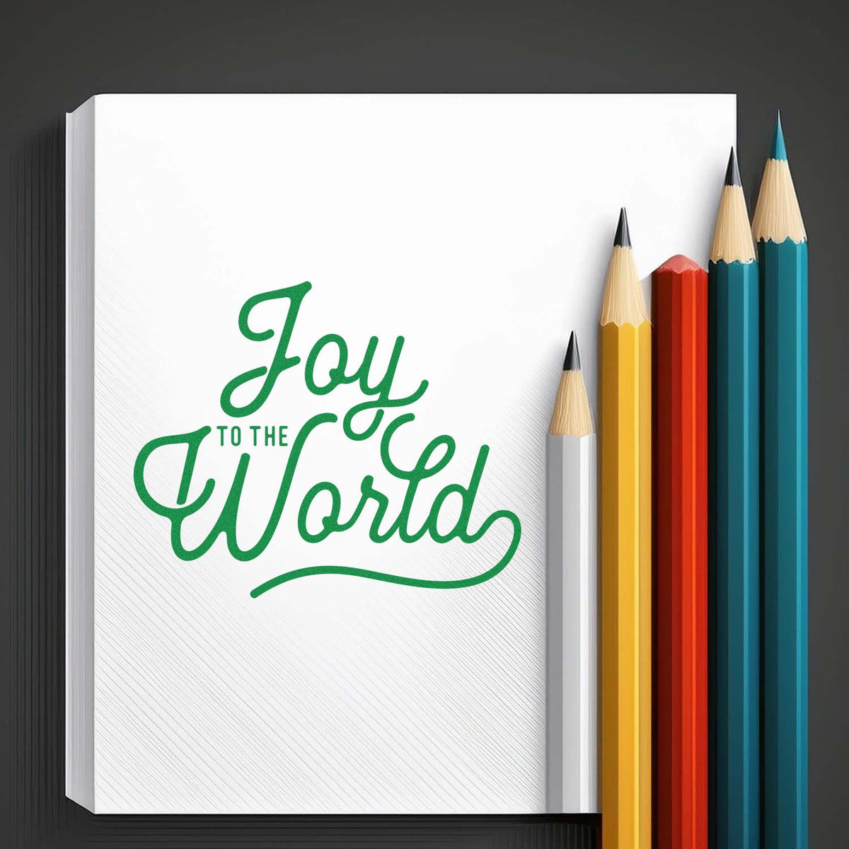 Joy To The World Script rubber stamp shown in green ink, stamped for projects such as big small album page.
