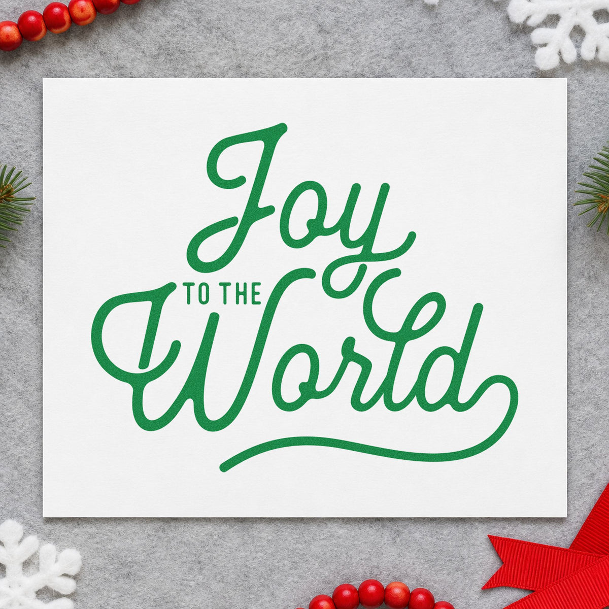 Joy To The World Script craft stamp imprinted in green ink on paper, a design suited to framed big print.