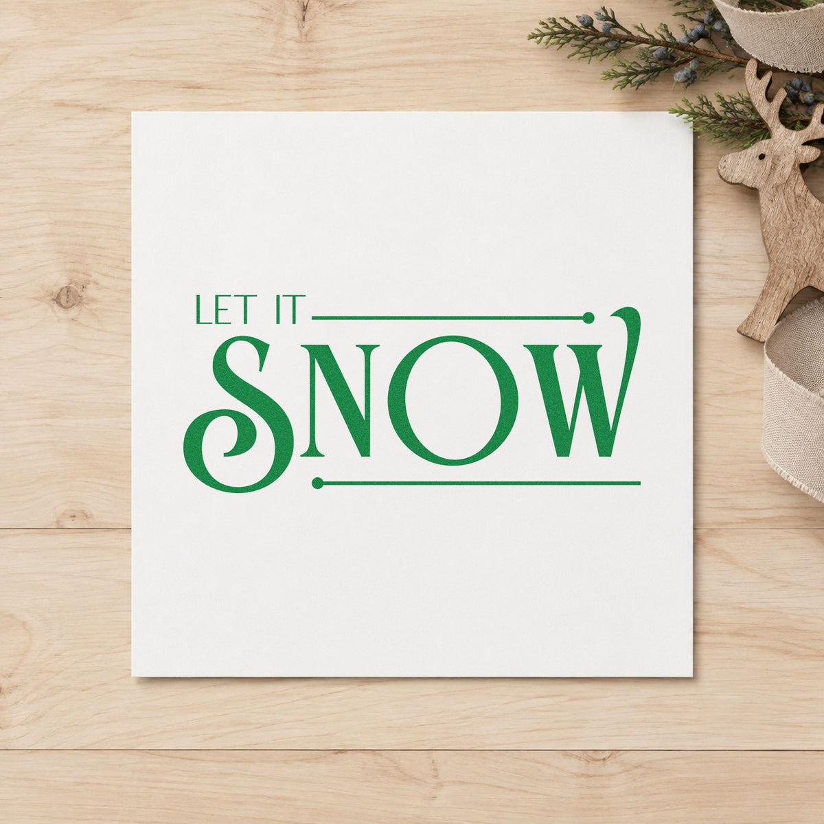 Let It Snow Serif craft stamp imprinted in green ink on paper, a design suited to framed fitting room.