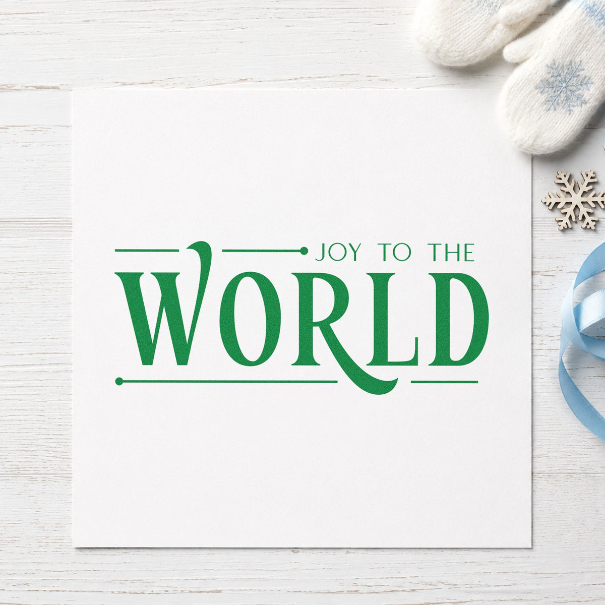 Joy To The World Serif craft stamp imprint in green ink on a handmade project, one idea being program close cards.