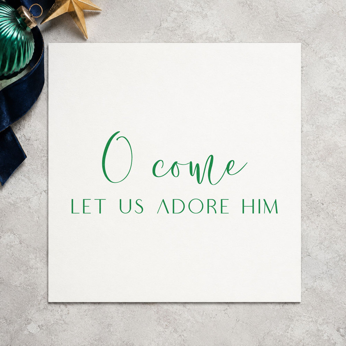 O Come Let Us Adore Him craft stamp imprinted in purple ink on paper, a design suited to framed chancel ledge.