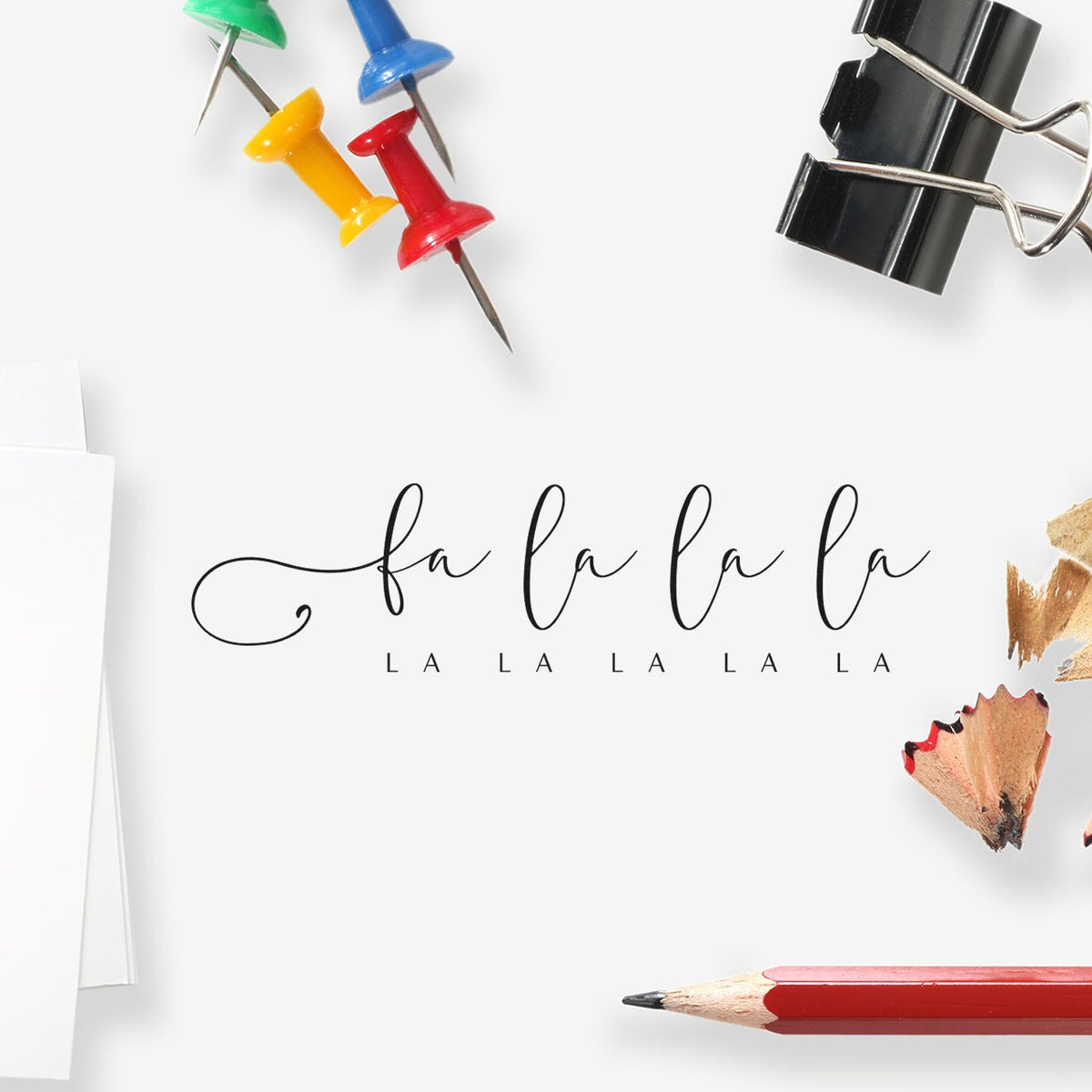 Fa La La Looping Holiday Script Premium Wooden Stamp - Vintage Pro imprint stamped in black ink. The phrase "fa la la la" appears in thin looping script above a row of small spaced "la" lettering.