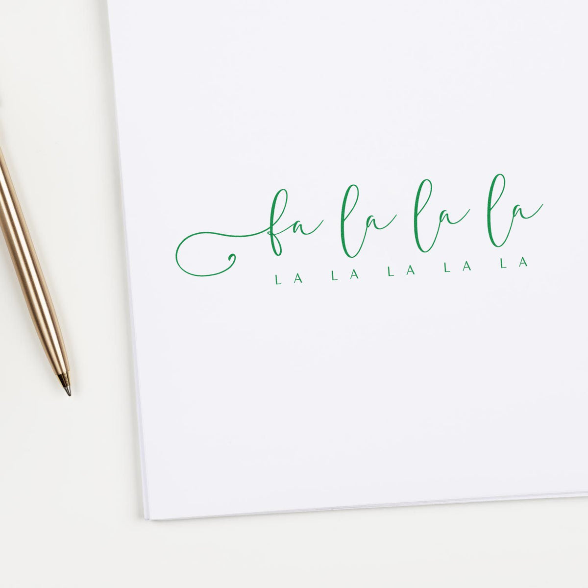 Fa La La Holiday Script rubber stamp shown in purple ink, stamped for projects such as carol album page.