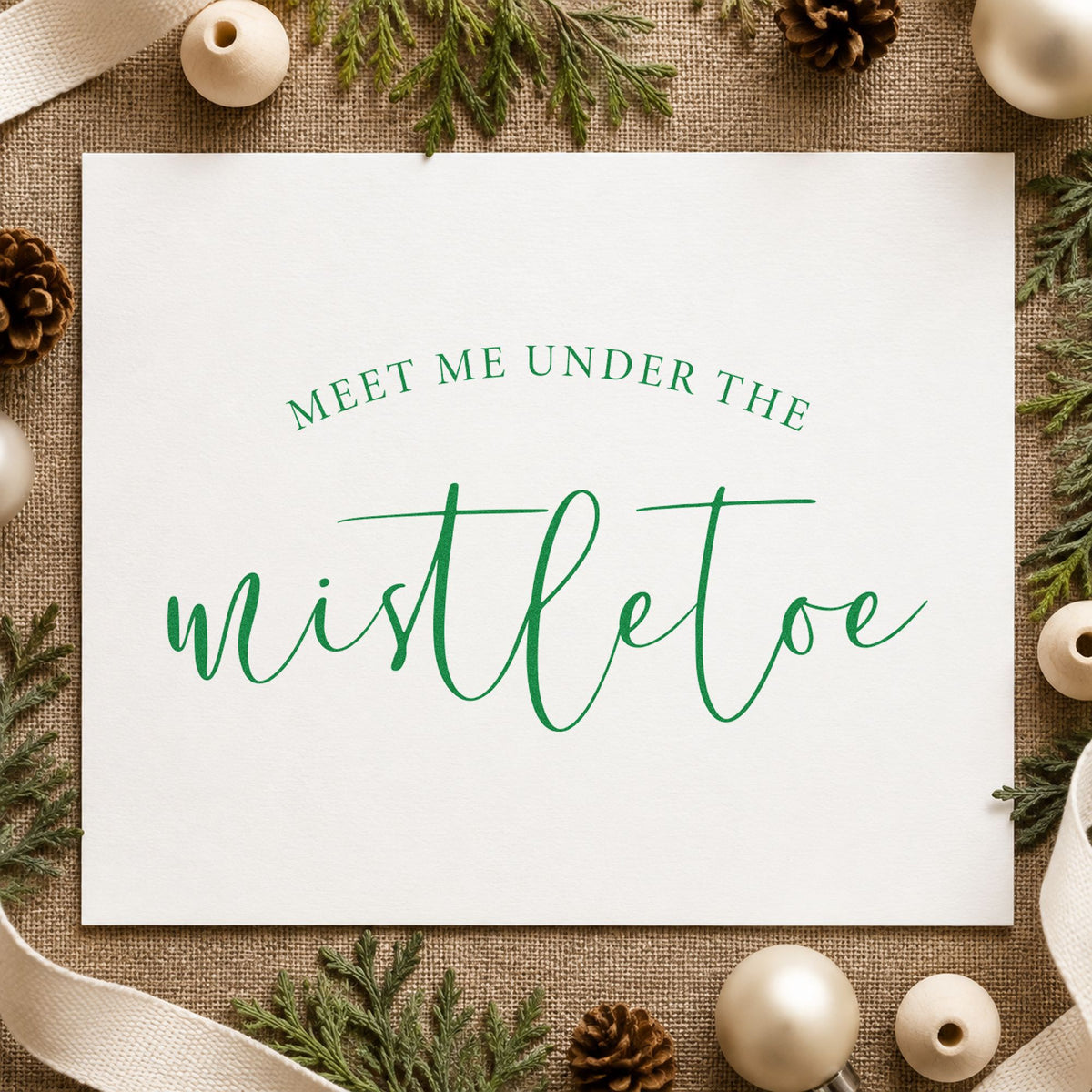 Meet Me Under Mistletoe Script craft stamp imprinted in green ink on paper, a design suited to framed oval mat.