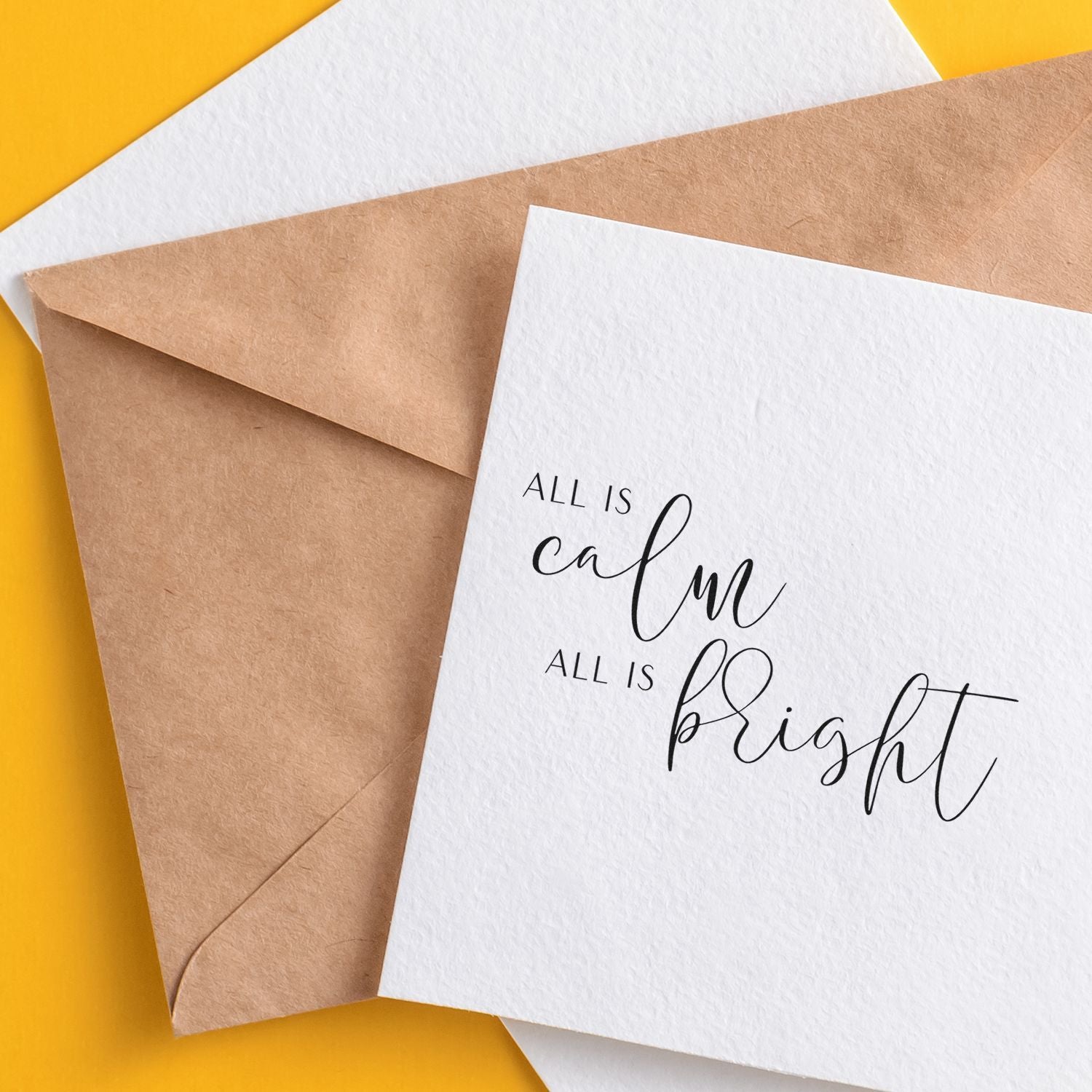 Minimal Christmas greeting card mockup with kraft envelope and All is calm, all is bright sentiment for rubber stamp designs.