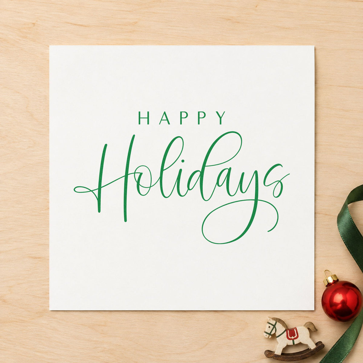 Happy Holidays Looped Script craft stamp imprinted in green ink on paper, a design suited to framed tall mat.