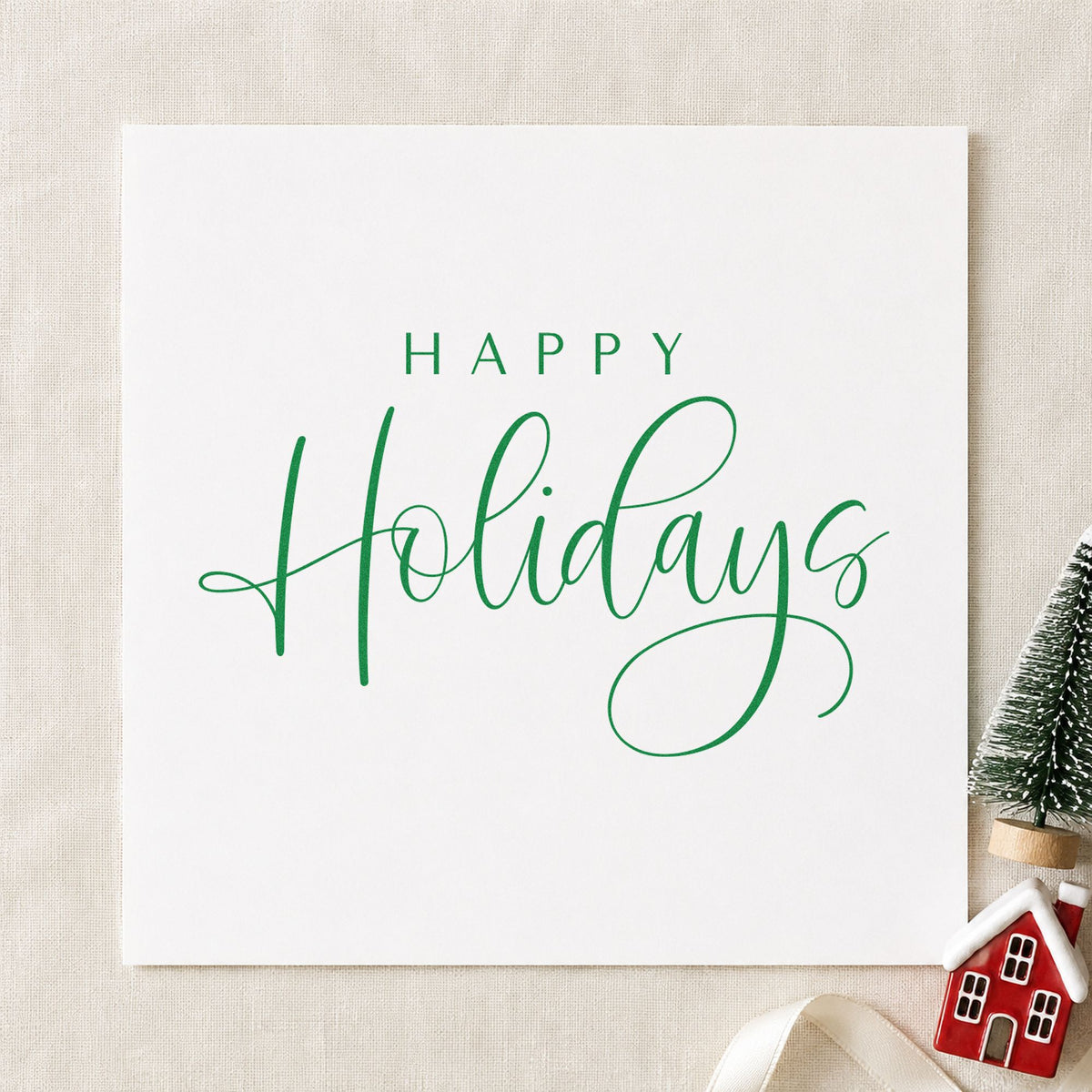 Happy Holidays Looped Script craft stamp imprint in green ink on a handmade project, one idea being formal card slips.