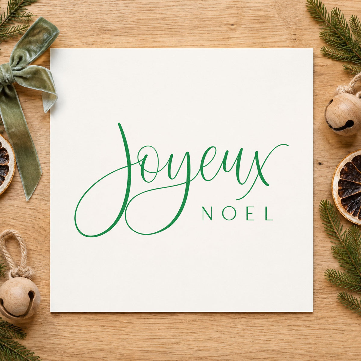 Joyeux Noel Fine Script craft stamp imprint in green ink on a handmade project, one idea being reveillon menu cards.