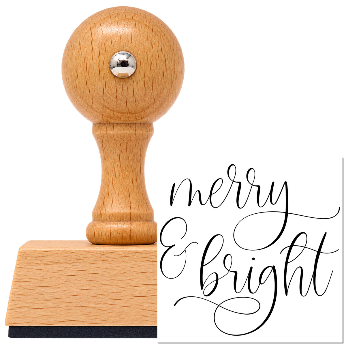 Merry And Bright Looped Script Vintage Pro rubber stamp in European beech wood with a round knob handle, shown beside its black imprint.