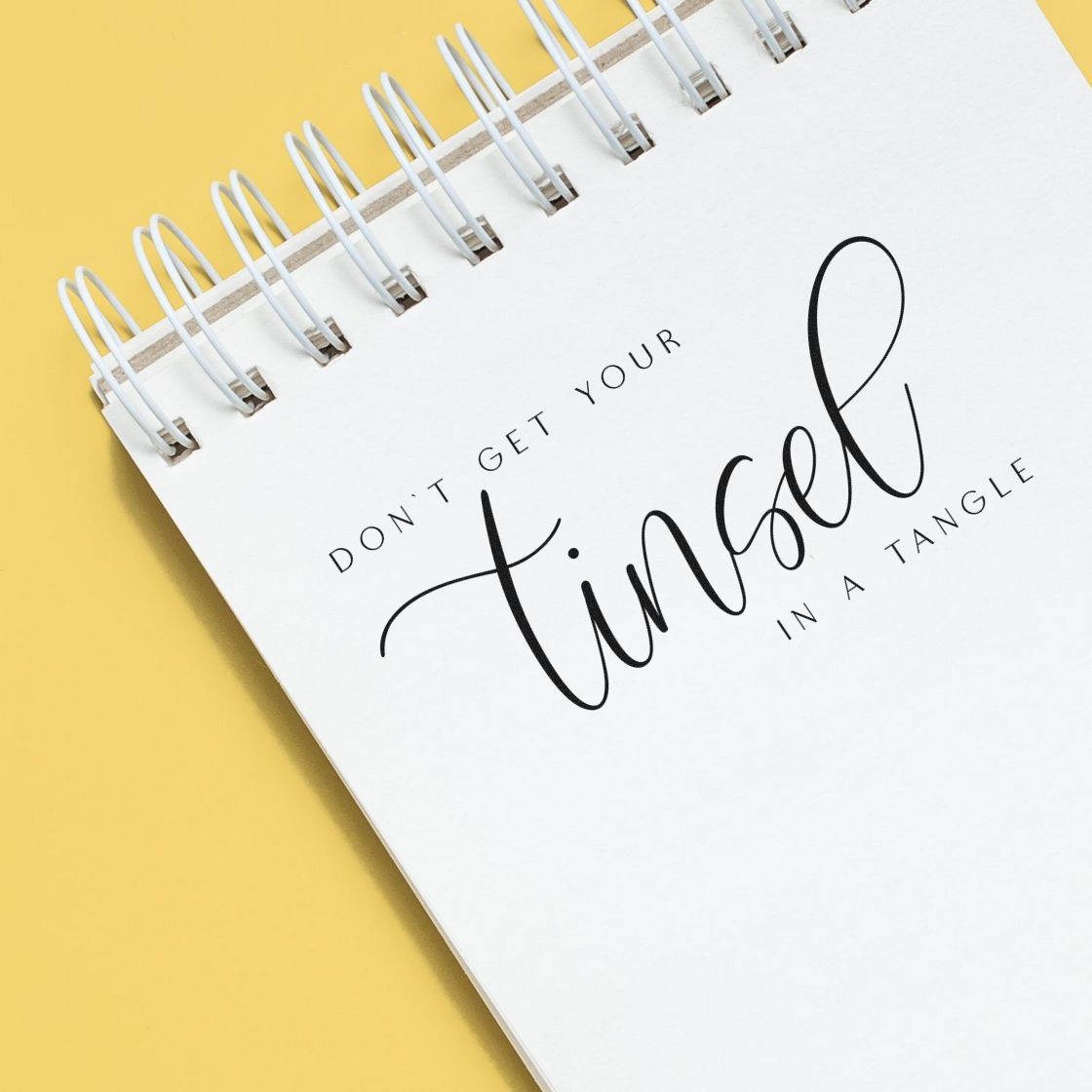 Don't Get Tinsel Tangled Script Lettering Stamp - Premium Vintage Pro Wooden imprint stamped in black ink. The phrase "Don't get your tinsel in a tangle" emphasizes "tinsel" in large flowing script.