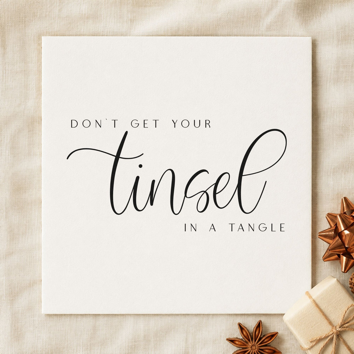 Don't Get Tinsel Tangled craft stamp imprint in black ink on a handmade project, one idea being untangle gift tags.