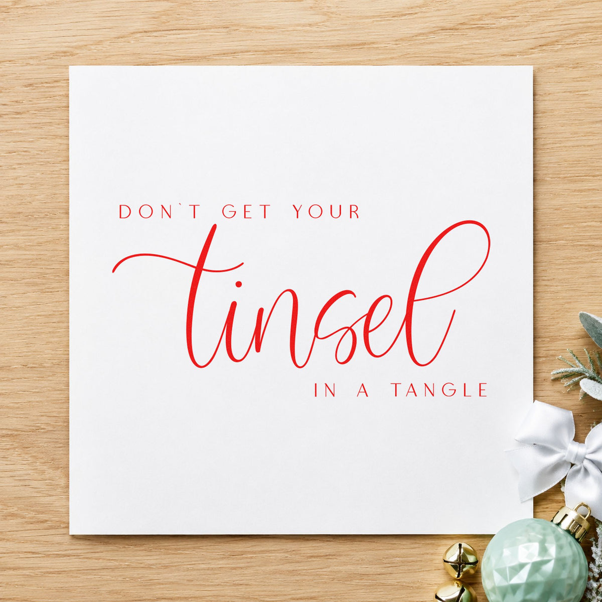 Don't Get Tinsel Tangled craft stamp in red ink on cardstock, an easy option for tea towel printing.