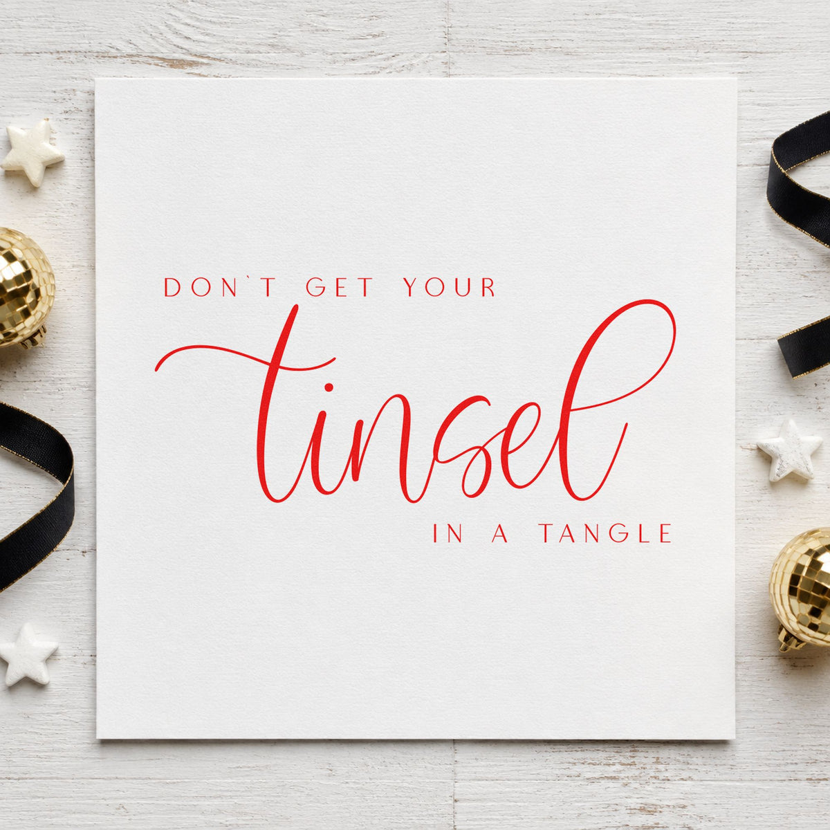 Don't Get Tinsel Tangled rubber stamp shown in red ink, stamped for projects such as cord reel labels.