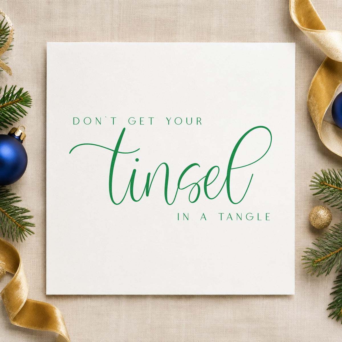 Don't Get Tinsel Tangled craft stamp imprint in green ink on a handmade project, one idea being reset break cards.