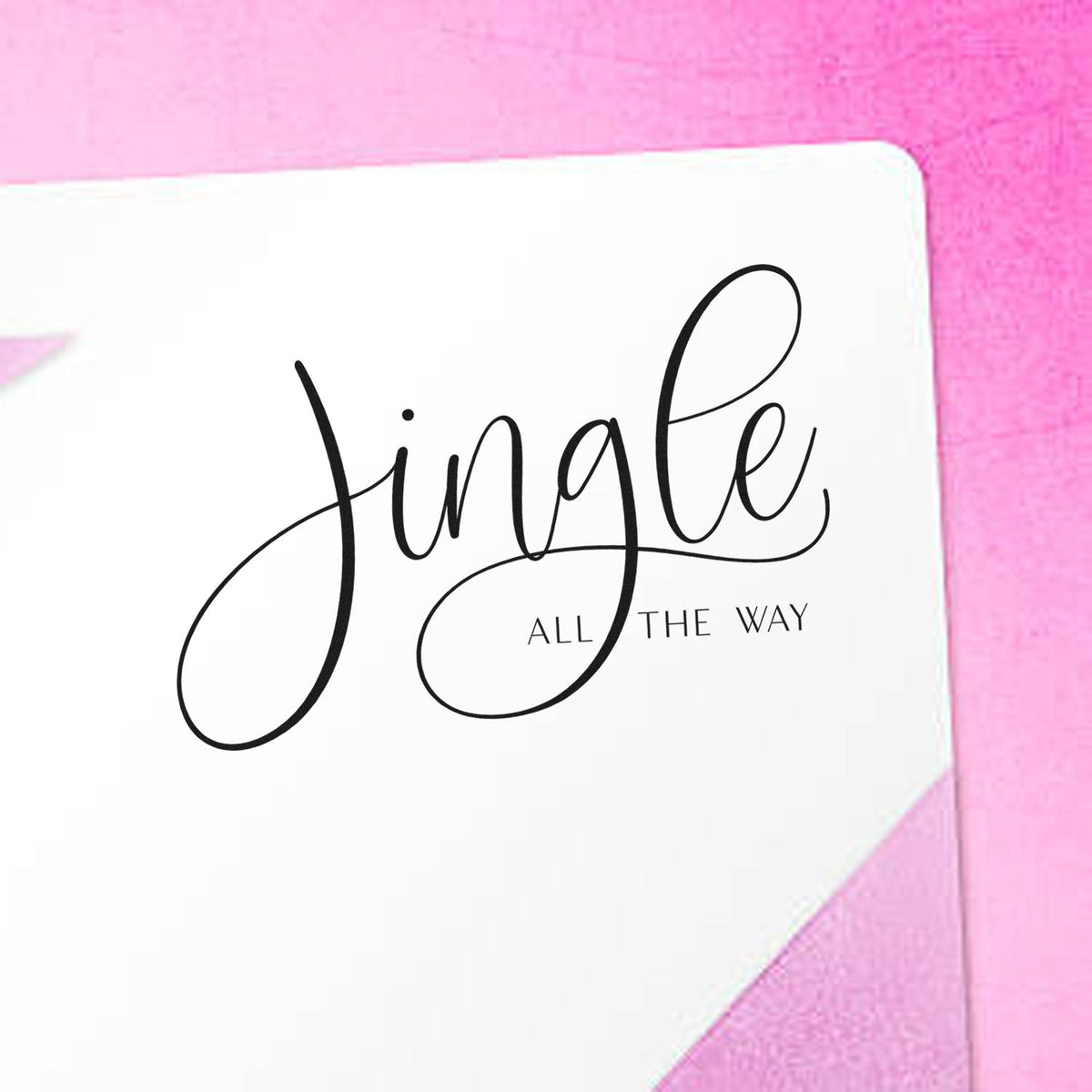 Jingle All The Way Calligraphy Premium Wooden Stamp - Vintage Pro imprint stamped in black ink. The word "Jingle" appears in large thin calligraphy with long loops above small "all the way" text.