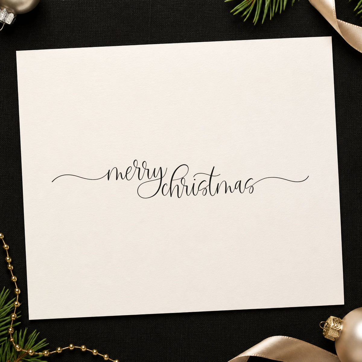 Merry Christmas Fine Flourishes craft stamp imprint in black ink on a handmade project, one idea being long slip gift tags.