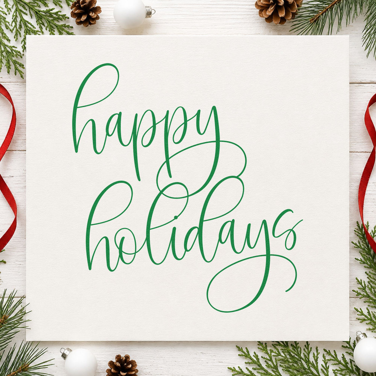 Happy Holidays Flourished Calligraphy craft stamp imprint in green ink on a handmade project, one idea being tea card slips.