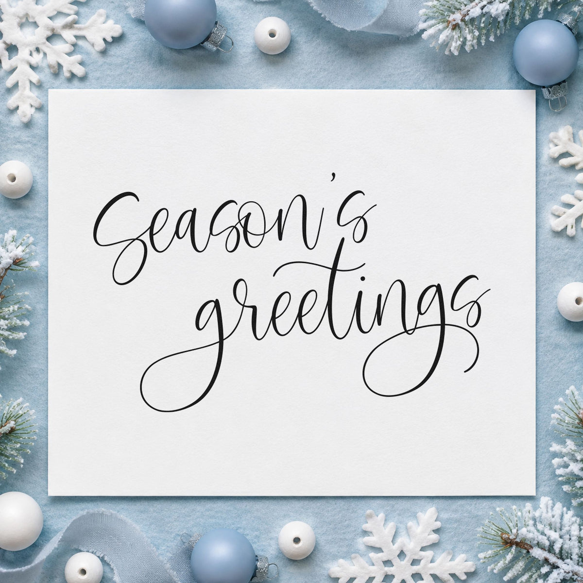 Season's Greetings Fine Calligraphy craft stamp imprint in black ink on a handmade project, one idea being ribbon tie gift tags.