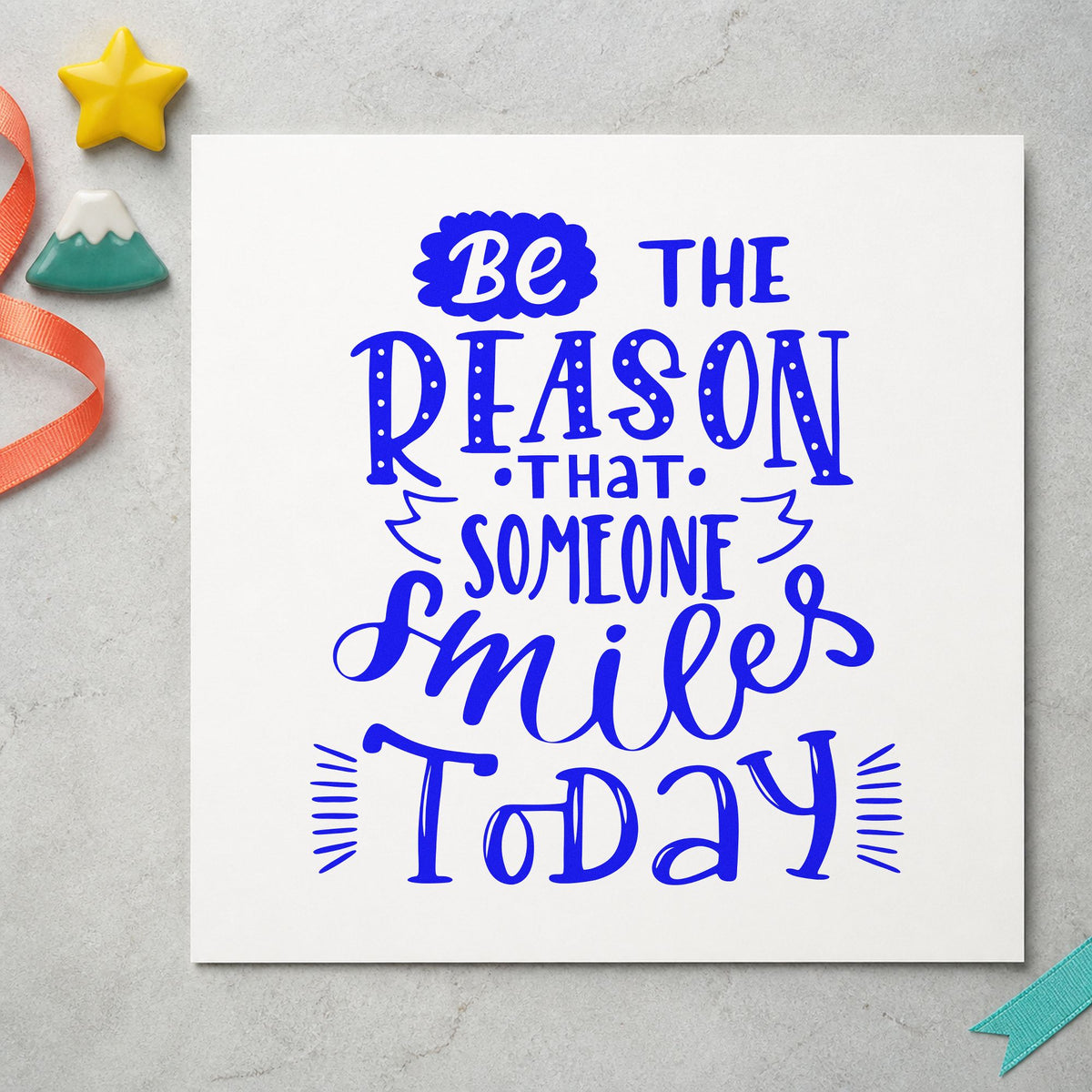 Be Someone's Reason To Smile craft stamp imprinted in blue ink on paper, a design suited to framed desk plaque.