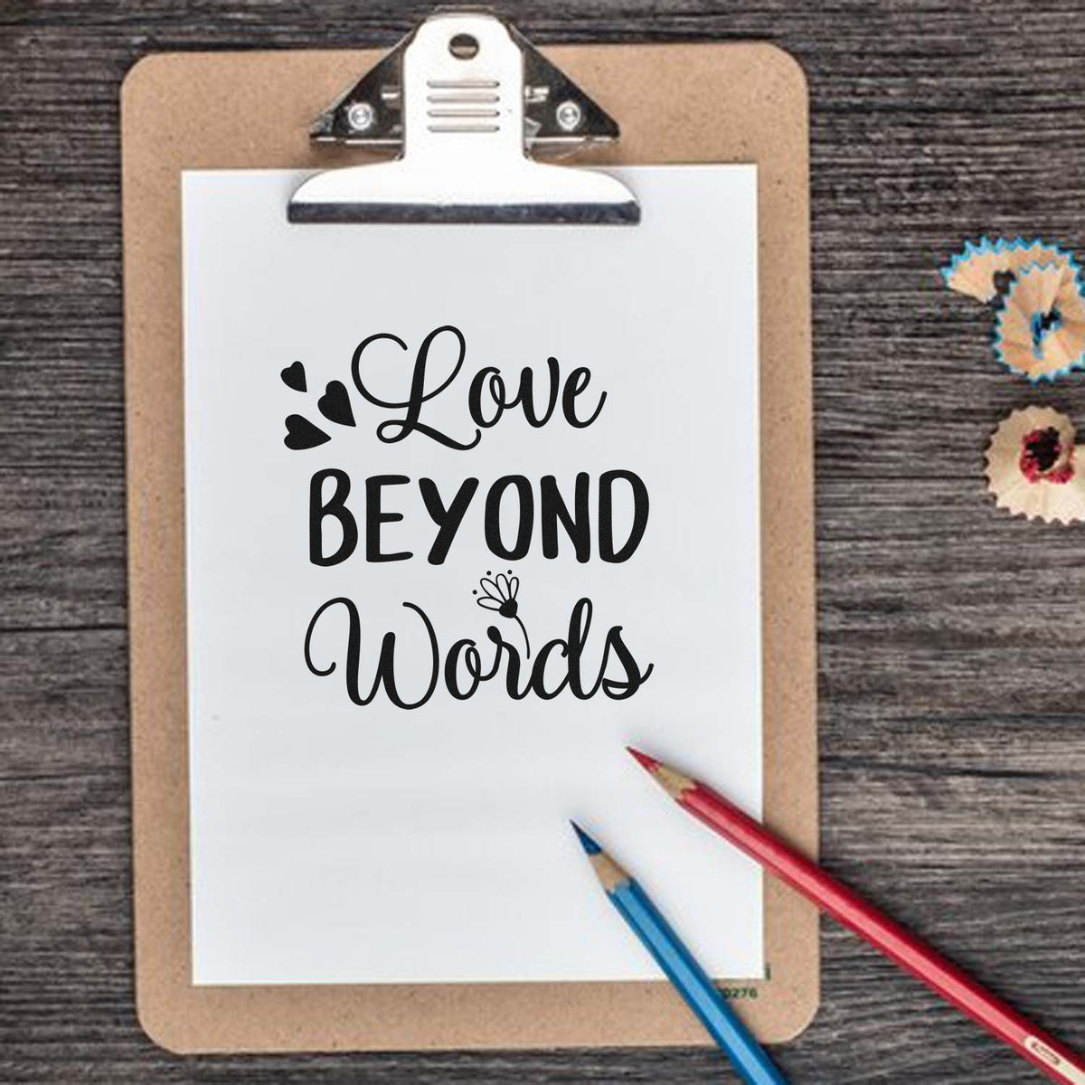 Love Beyond Words Hearts Premium Wooden Stamp - Vintage Pro imprint stamped in black ink. The words "Love beyond words" appear with small hearts and a little flower.